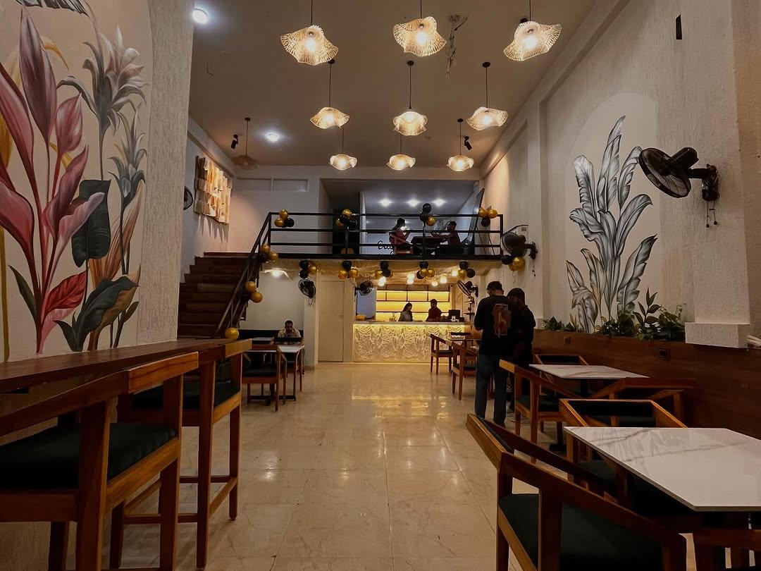 Interior of Fuell Station Cafe with botanical murals and warm lighting